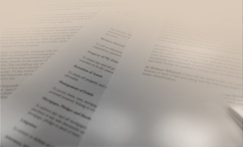 Close-up of a document with blurred text, focusing on the title Property of My Estate and other related headings. The page appears to be part of a legal or estate planning document, with a soft, vignette effect around the edges.